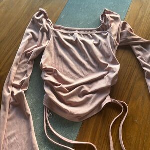 Pink long sleeve top with a side tie